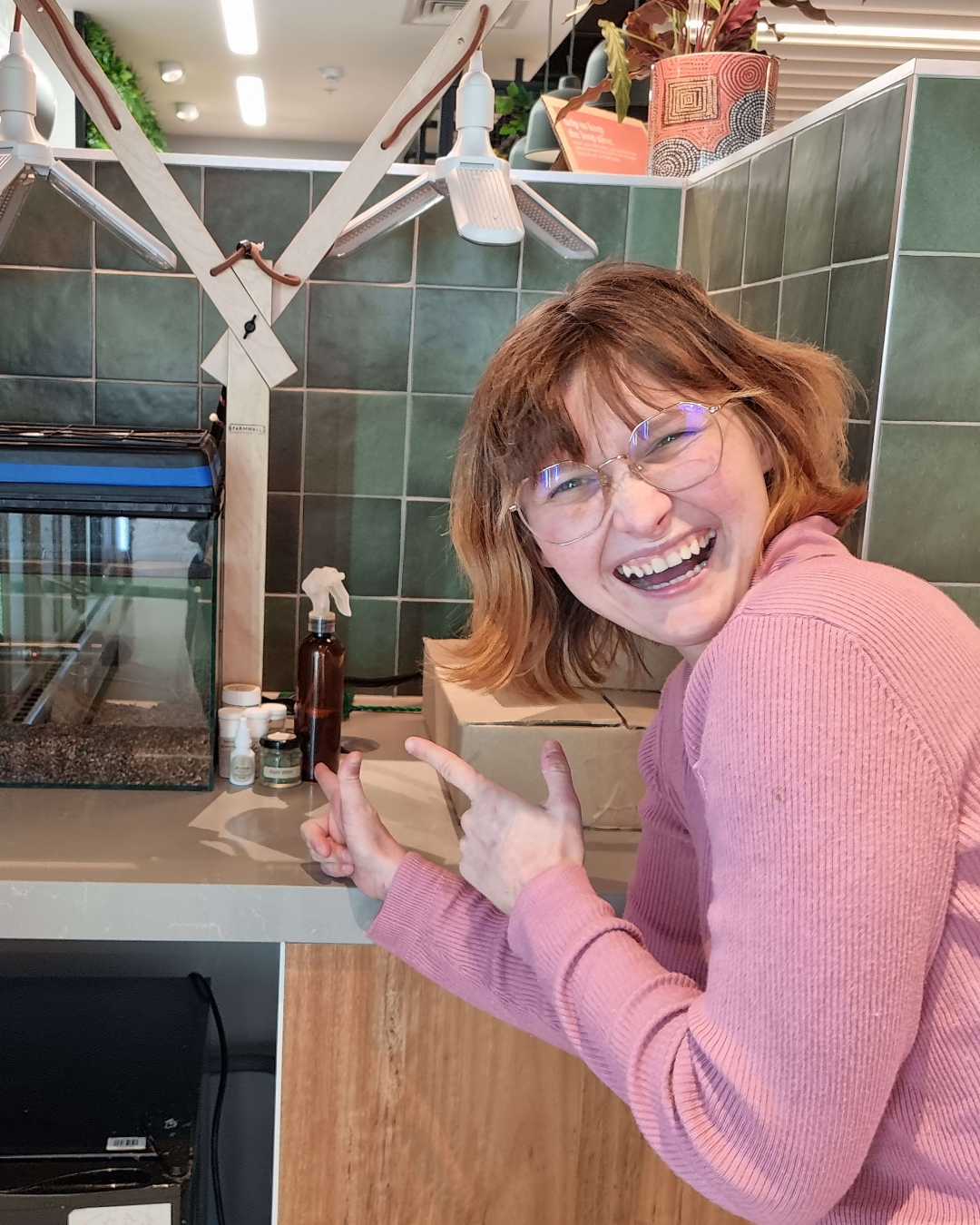 A smiling woman pointing at her newly delivered Farmwall Pocket